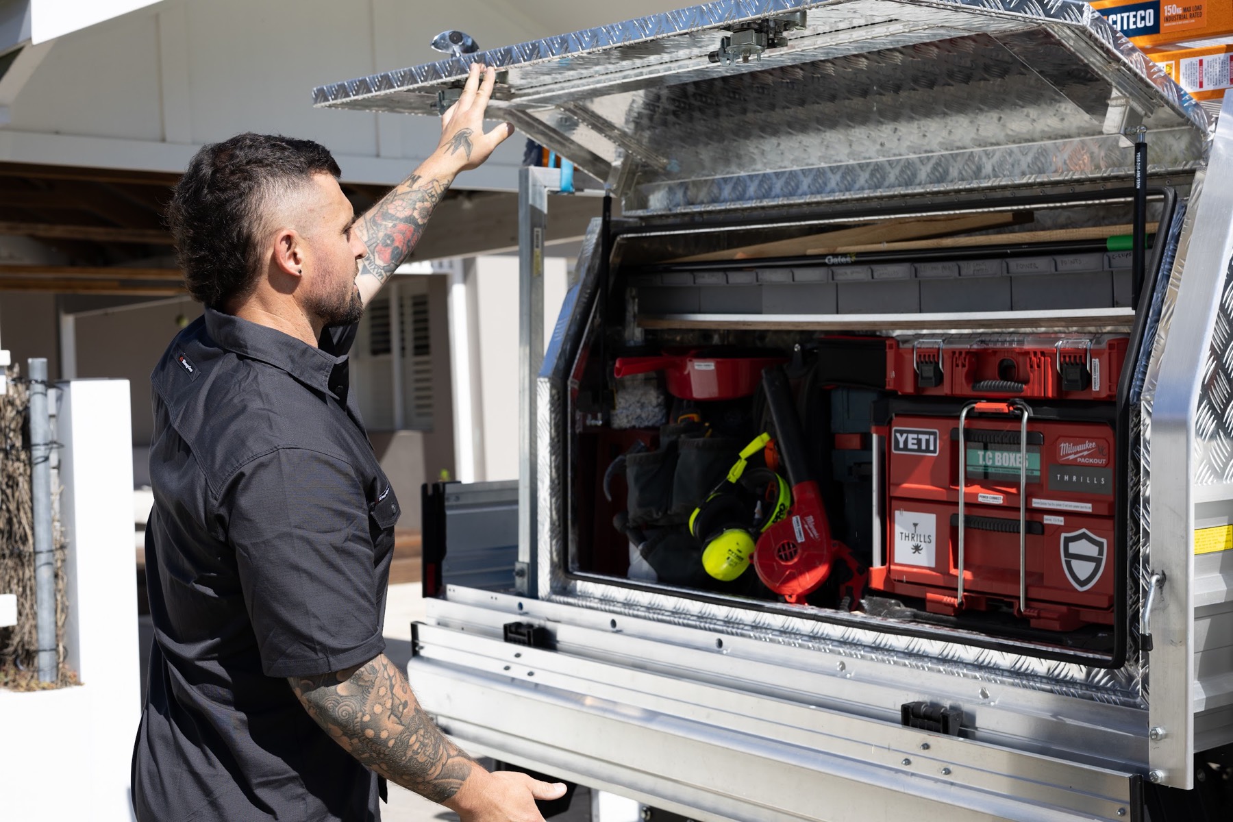 Reaching into the ute canopy for tools