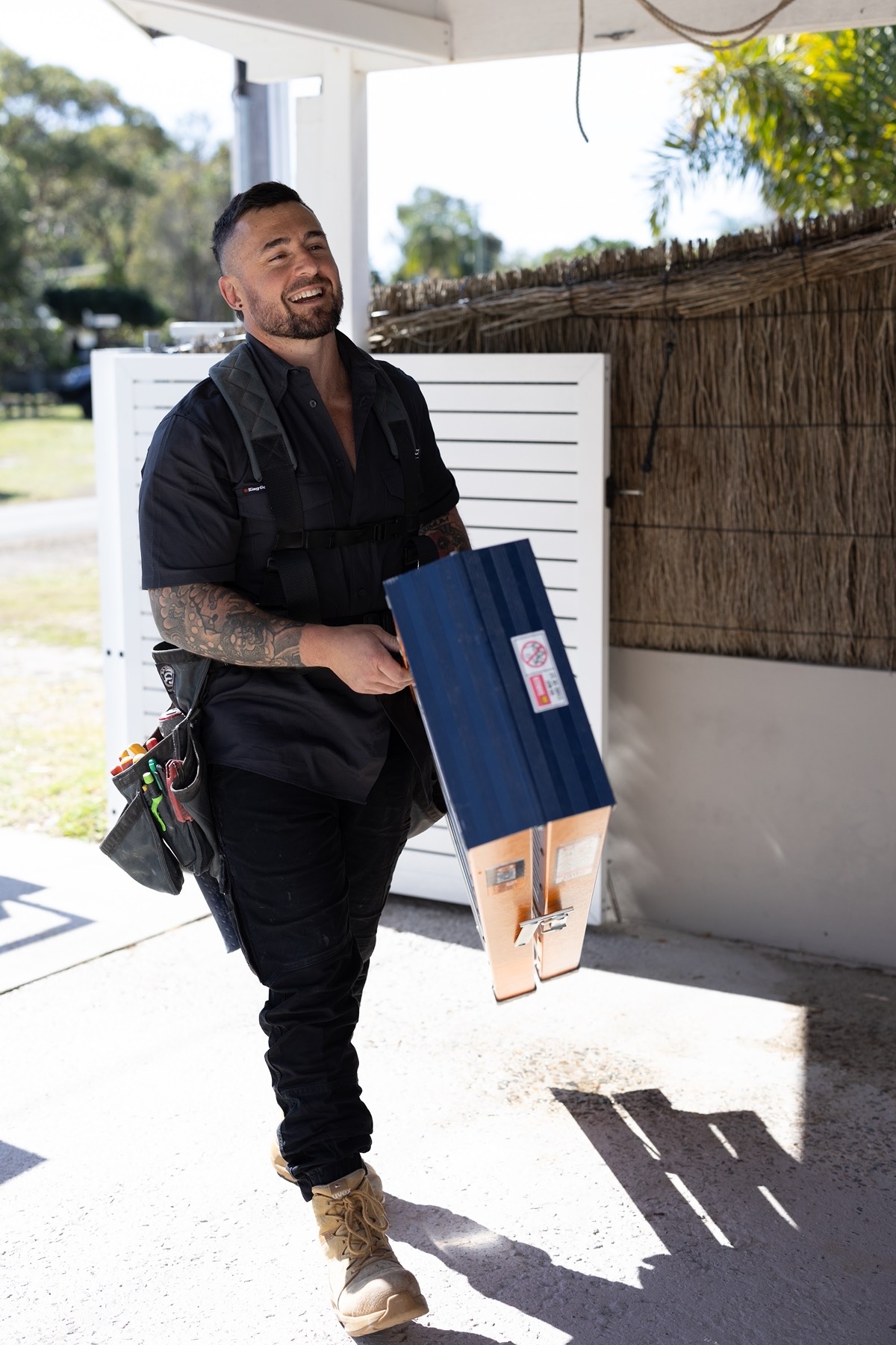 Vincent carrying a new fitting in from the ute