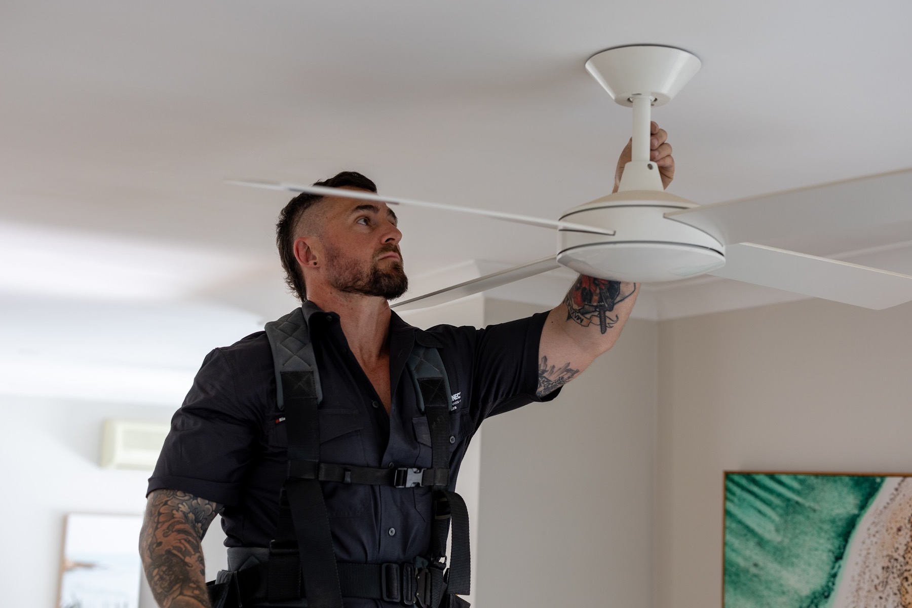 Vincent installing a ceiling fan in a Northern Beaches home