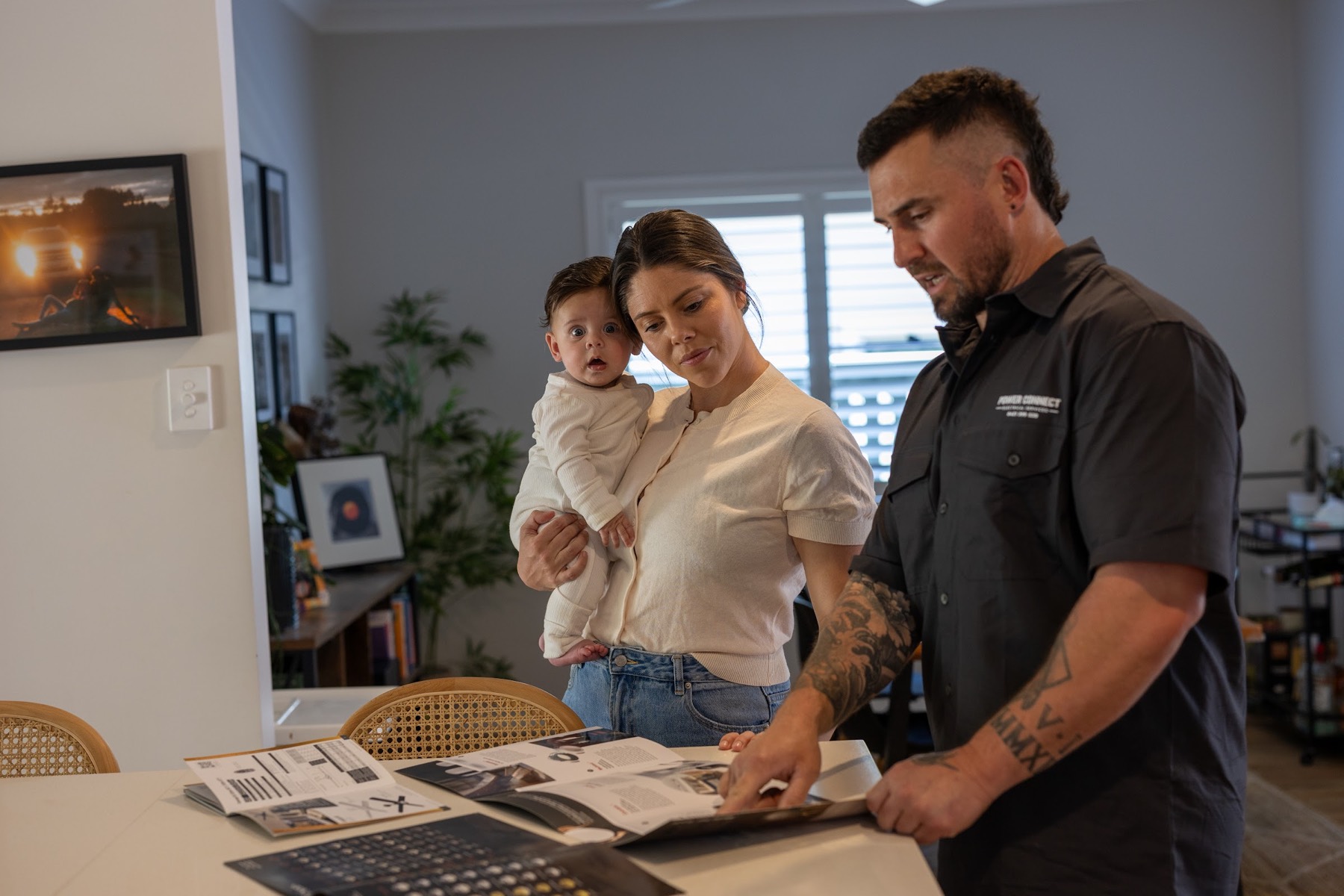 Vincent going through fitting options and a written quote at the kitchen table
