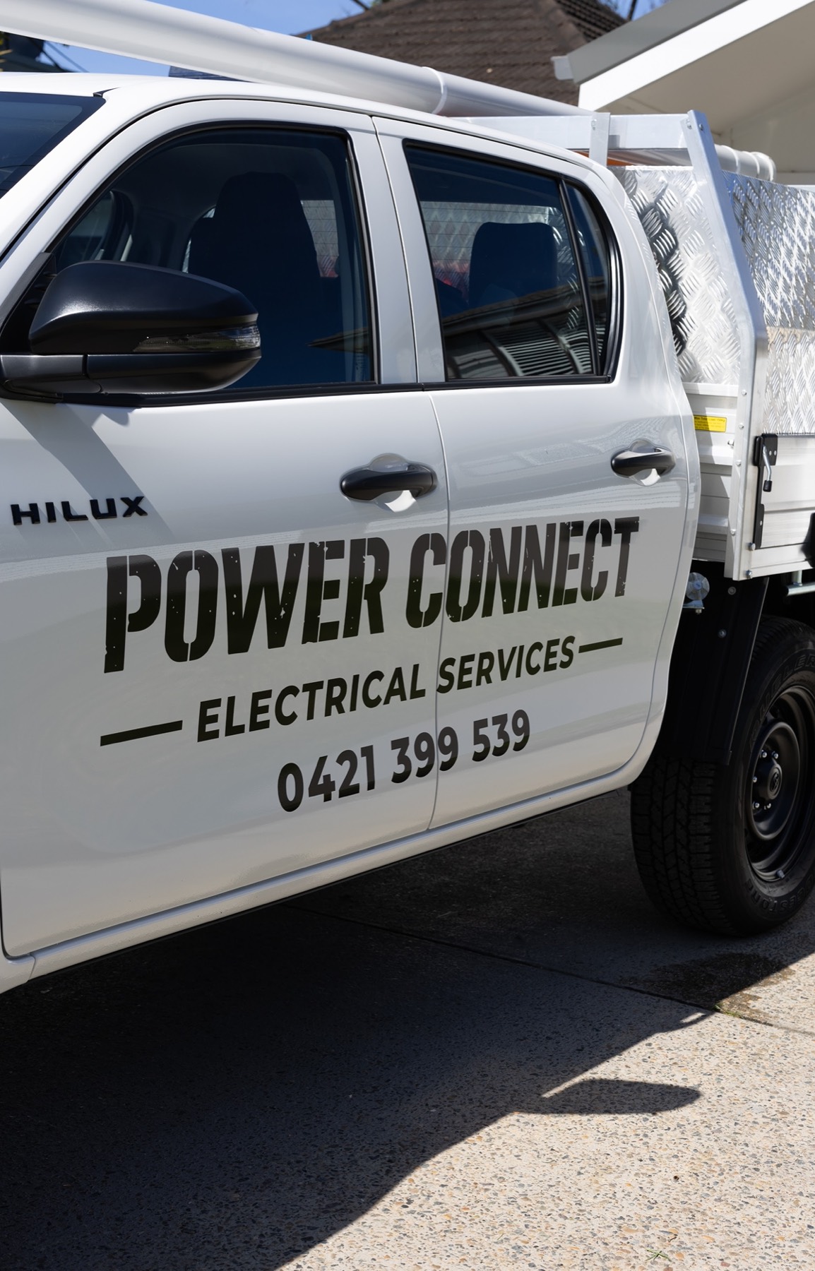 Power Connect branding and phone number on the ute door