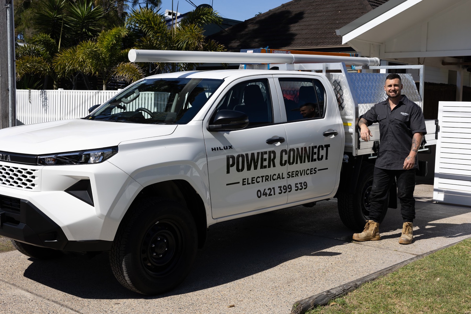 Vincent beside the signwritten Power Connect ute