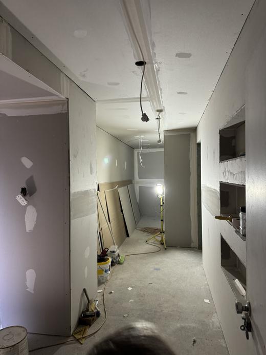 Renovation rough in with cabling run through a framed and sheeted hallway